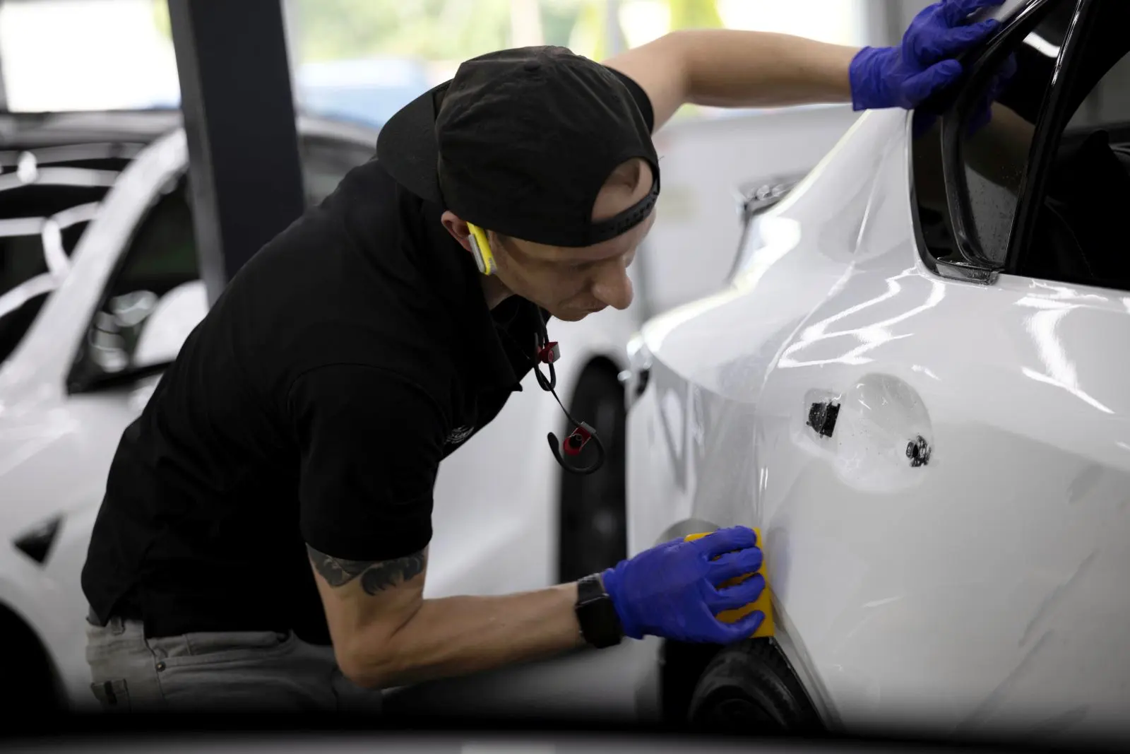 Sun Stoppers paint protection film installer working on a vehicle