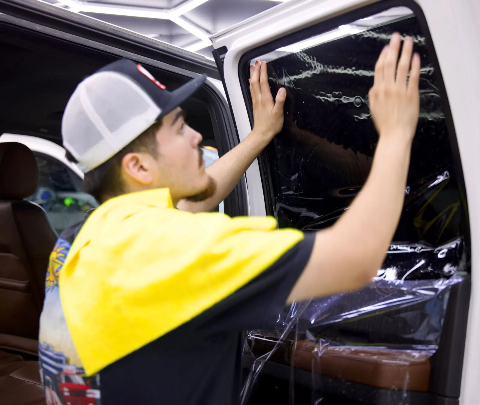 Sun Stoppers window tint installer working in the shop