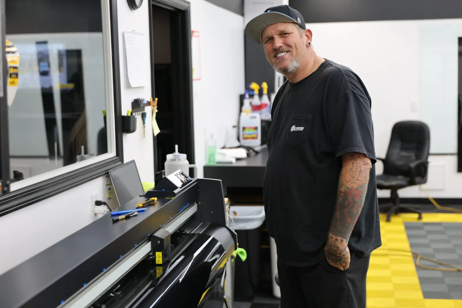 Jason beside window film equipment at Sun Stoppers Matthews