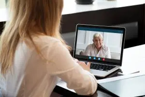 Young woman talk on video call with senior father