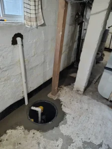 Interior drainage system and Pit Boss sump pump installation in a basement in New Castle PA