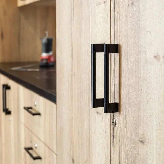 High-quality wood-grain garage storage cabinets with black handles installed by Higgins Distribution in Wichita, KS.