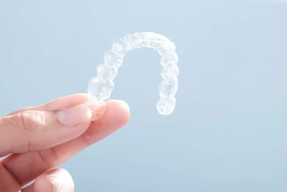 Hand holding a removable retainer