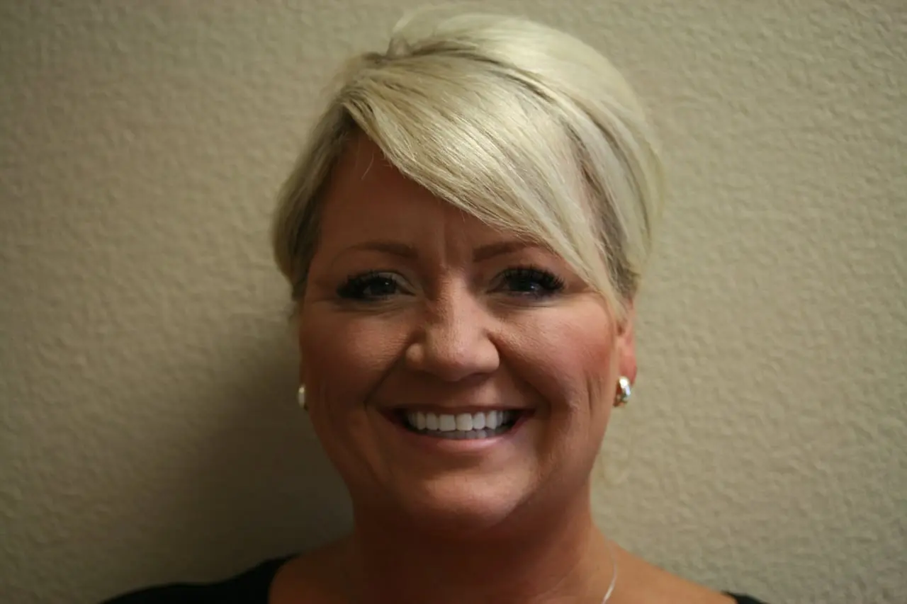 Woman smiling showing her teeth after Invisalign treatment