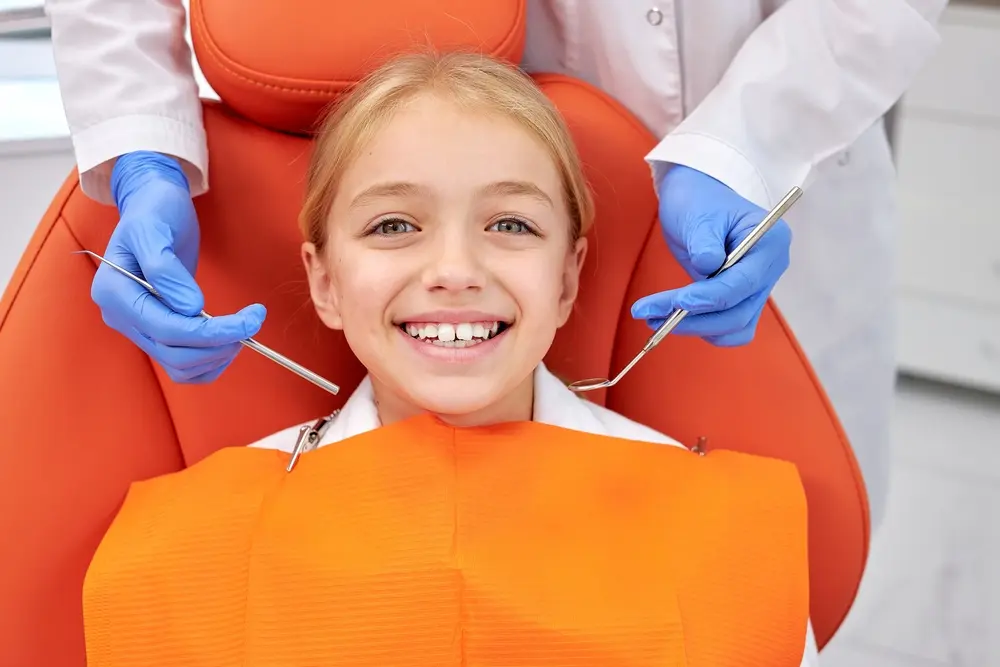 Little girl in a dental chair, showing the importance of pediatric dentistry