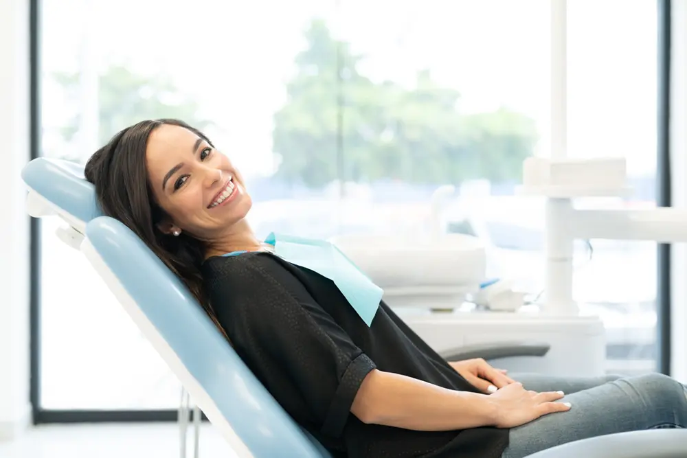 Woman in a dentist chair after receiving comprehensive dental care