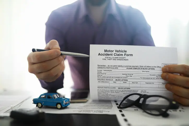 The insurance agent signs a document. Car insurance policy. Auto insurance policy. Forms registration of the contract.
