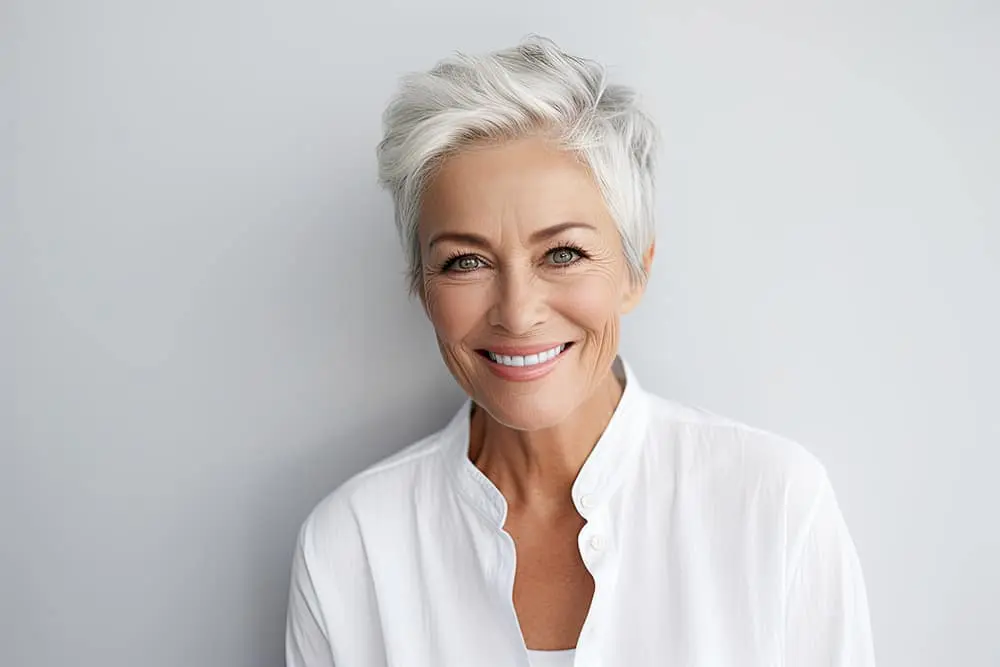 Woman smiling showing her perfect white teeth and the beauty of crown lengthening done at a top-rated dentist