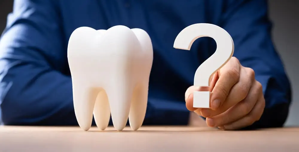 Image showing a huge tooth and a question mark