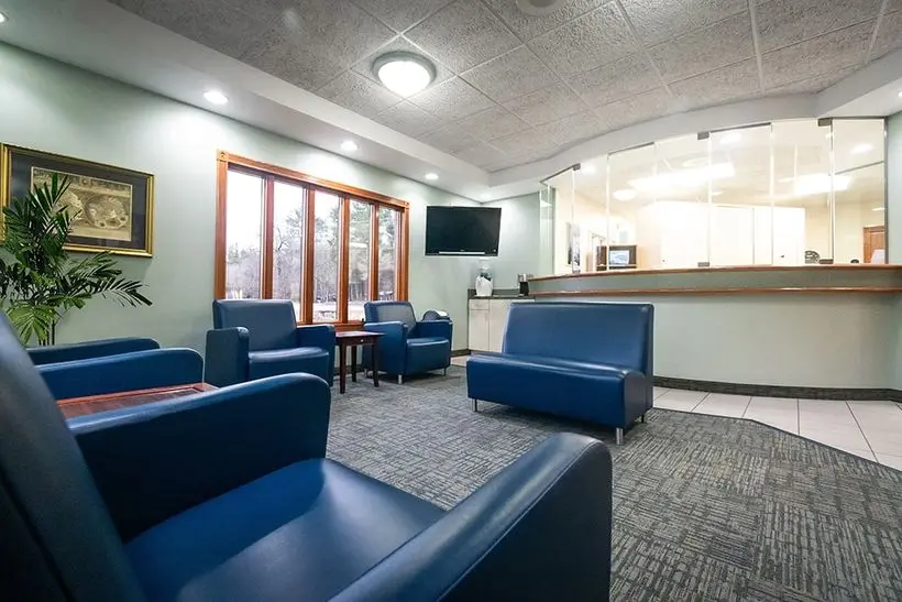 Blue cushioned seating area in the Knight Dental Care waiting room with large windows