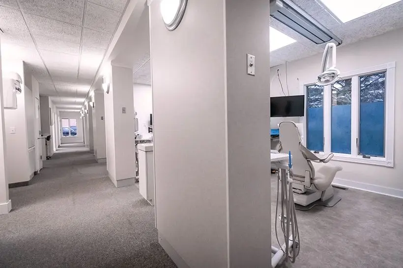 Hallway with exam rooms at Knight Dental Care, designed with neutral tones and modern lighting in Midland, MI