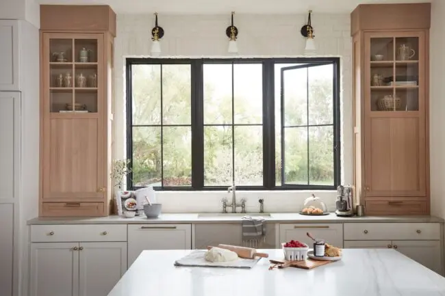 A stylish kitchen with sleek white cabinets and rich wooden countertops, offering a contemporary and cozy design.