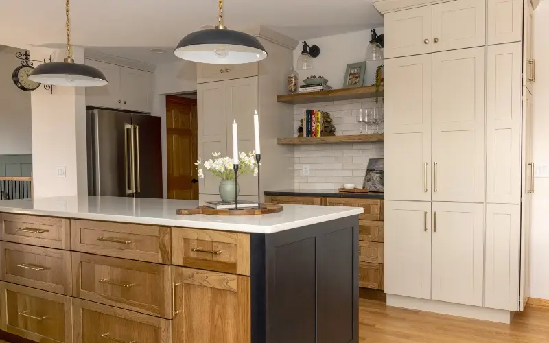 A modern kitchen with wooden cabinets and a stylish black countertop, creating a warm and contemporary atmosphere.