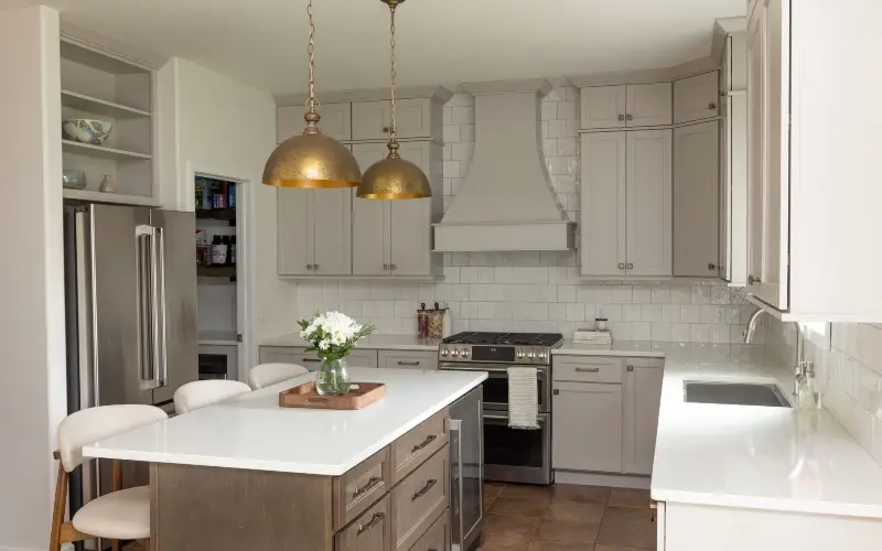 A modern kitchen featuring white cabinets and a spacious island, designed for functionality and style.