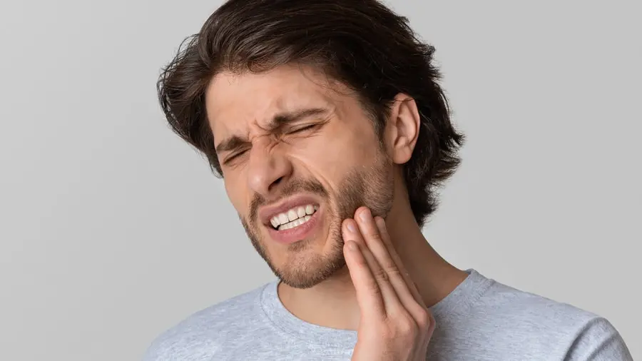man with painful tooth