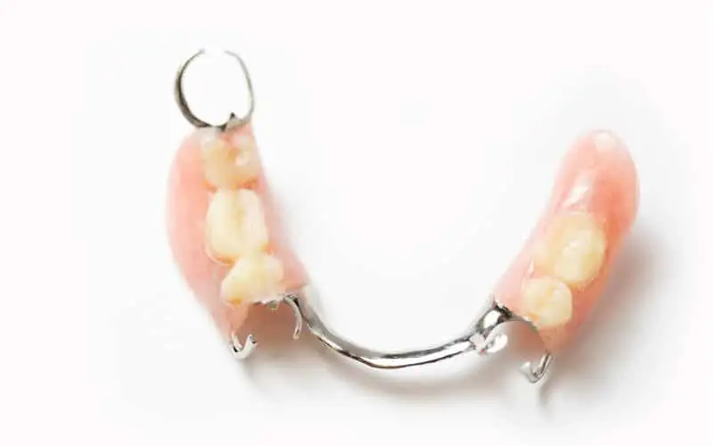 close up shot of a partial denture on white background