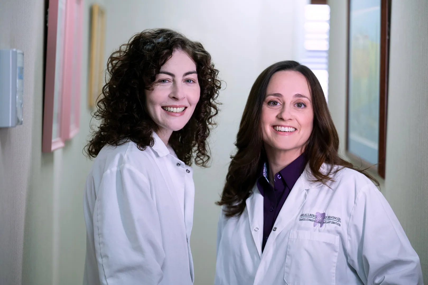 Home 20 Two female dentists standing together in white coats – Sedation Dentistry in Westbury, NY – Smallberg & Satornino, DDS, PLLC