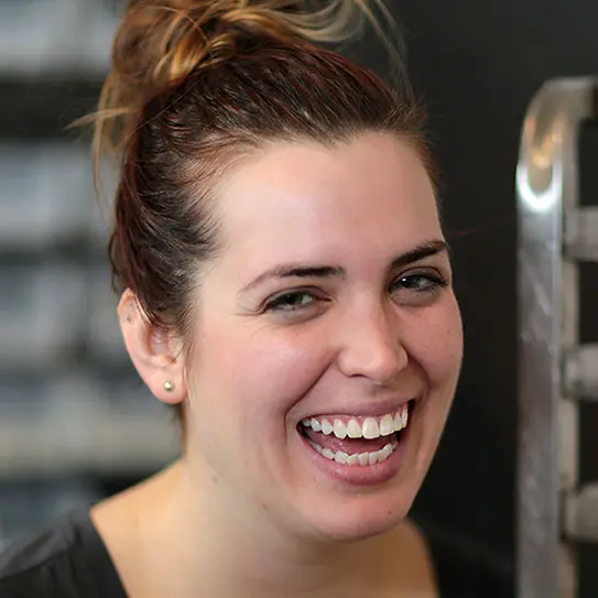 patient smiling after getting her dental implant restoration in Raleigh, NC at VP Dental.