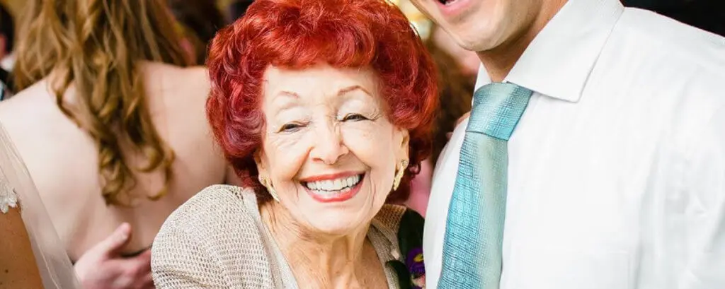 Smiling elderly woman showing bright teeth, highlighting full and partial dentures