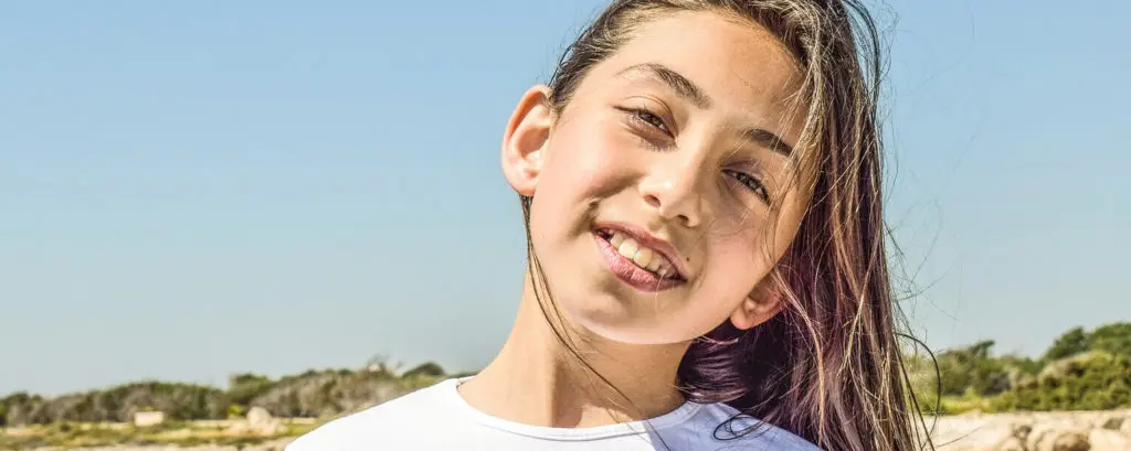 Functional Orthodontics | VP Dental | Functional Orthodontics in Raleigh Smiling young girl with visible dental alignment, showcasing functional orthodontic results outdoors