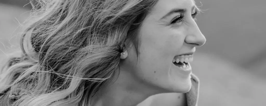 Periodontics | VP Dental | Periodontics A smiling woman with healthy teeth, captured in a black-and-white close-up