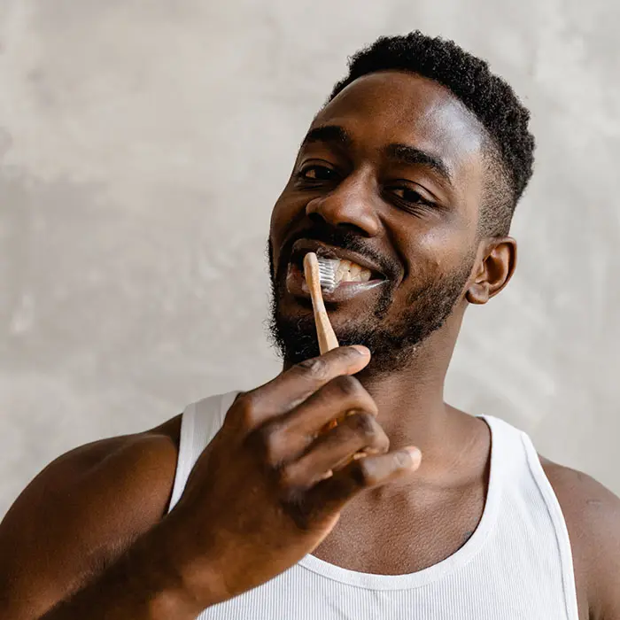 Tips for Men’s Oral Health | VP Dental | Stop Chewing Ice Patient brushing his teeth after visiting our dentistry for a dental cleaning in Raleigh, NC