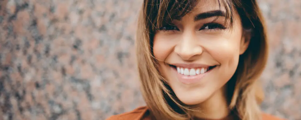 Smile Makeover | VP Dental | smile makeovers, cosmetic dentist, raleigh Smiling woman with straight, bright teeth, representing the results of a smile makeover