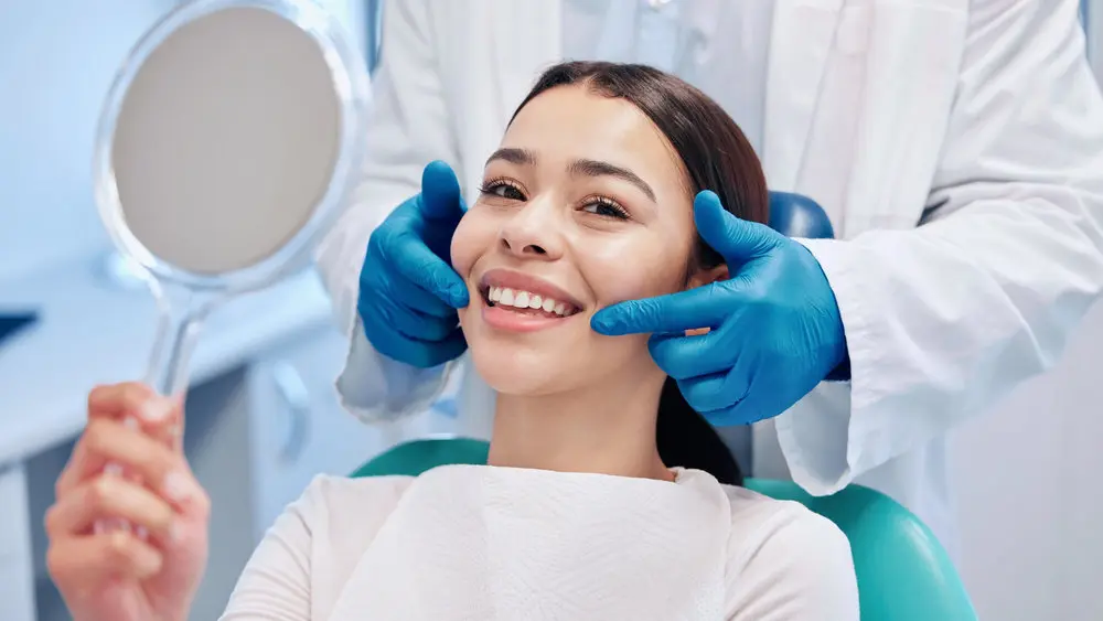 Smiling dental patient showing the importance of tooth bonding