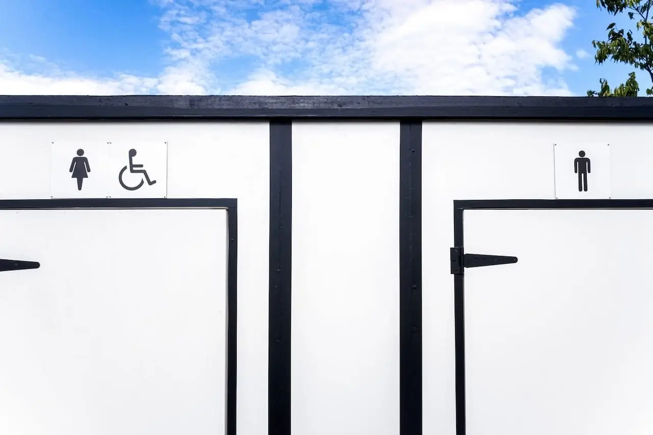 White portable toilets with space for women, men and disabled people.