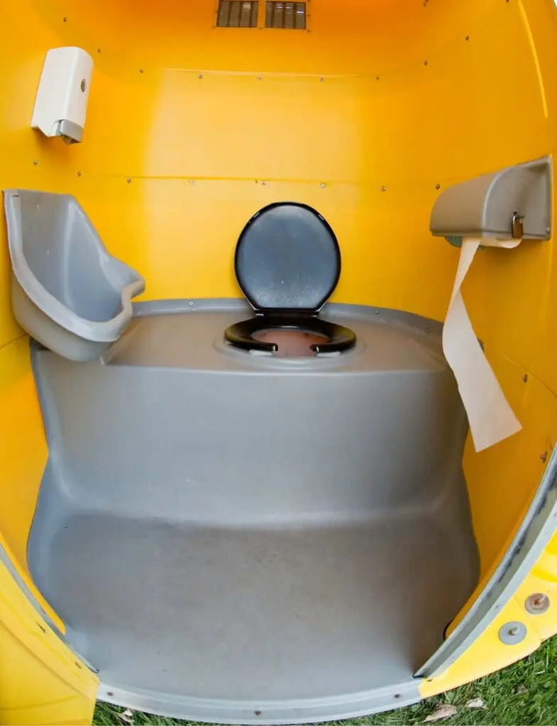 The inside of a cleaned yellow porta potty.