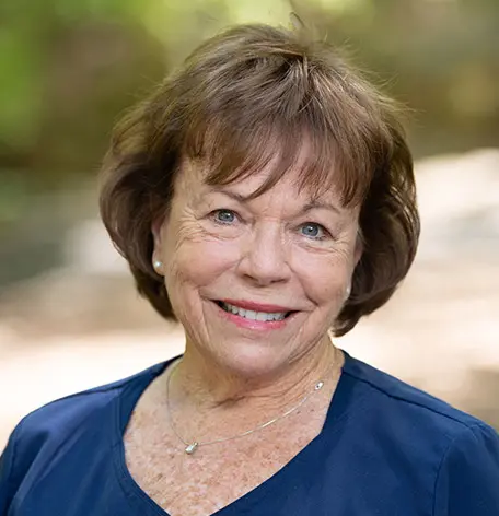 Head shot of Ellen, Registered Dental Hygienist, smiling warmly in blue uniform