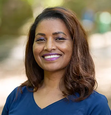 Head shot of Beth, Dental Assistant, smiling warmly in blue uniform