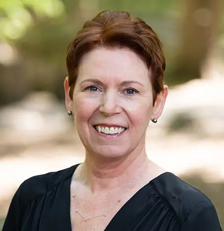 Head shot of Stacy, Insurance Coordinator, smiling warmly in a black top