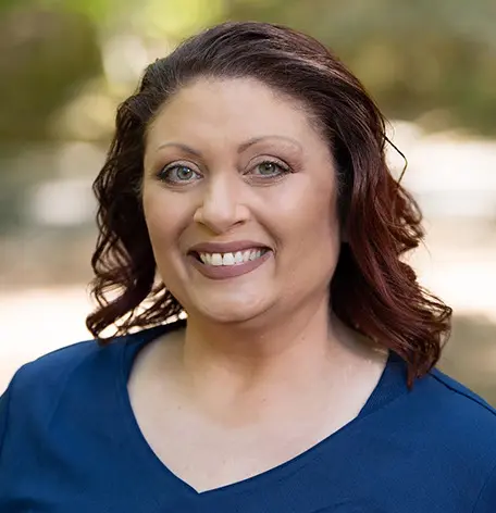 Head shot of Windy, Dental Assistant, smiling warmly in blue uniform