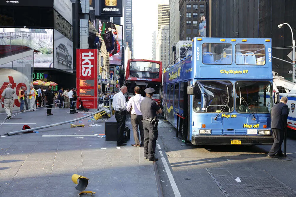 Police officers beside a damaged sightseeing bus in New York City