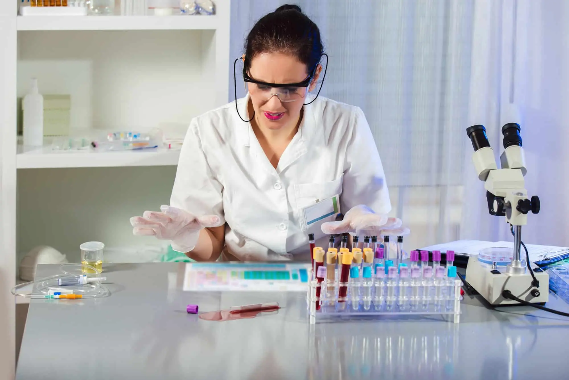 Scientist dropping liquid in a test tube in a laboratory. Accidents in the laboratory.