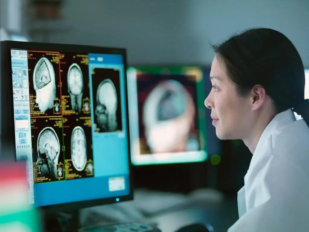 a neurologist looking at a brain scan