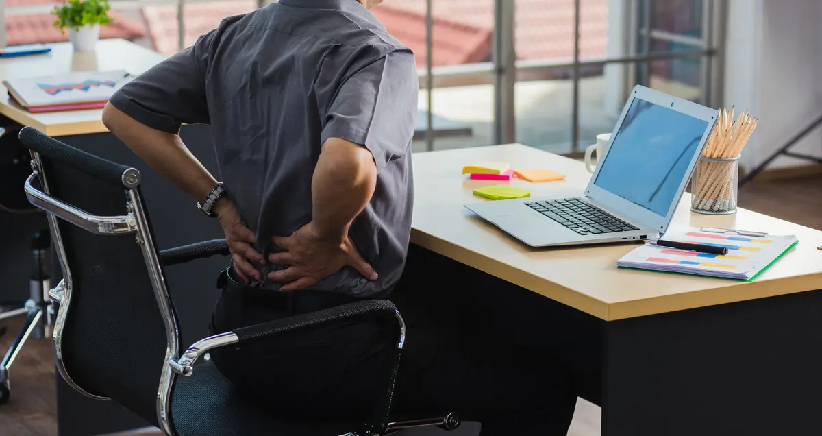 Asian hard senior businessman working with laptop computer has a problem with back pain. Old man feeling pain after sitting at desk long time, Healthcare and medicine office syndrome concept