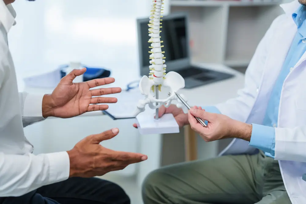 doctor discussing spinal condition or syndrome with the patient