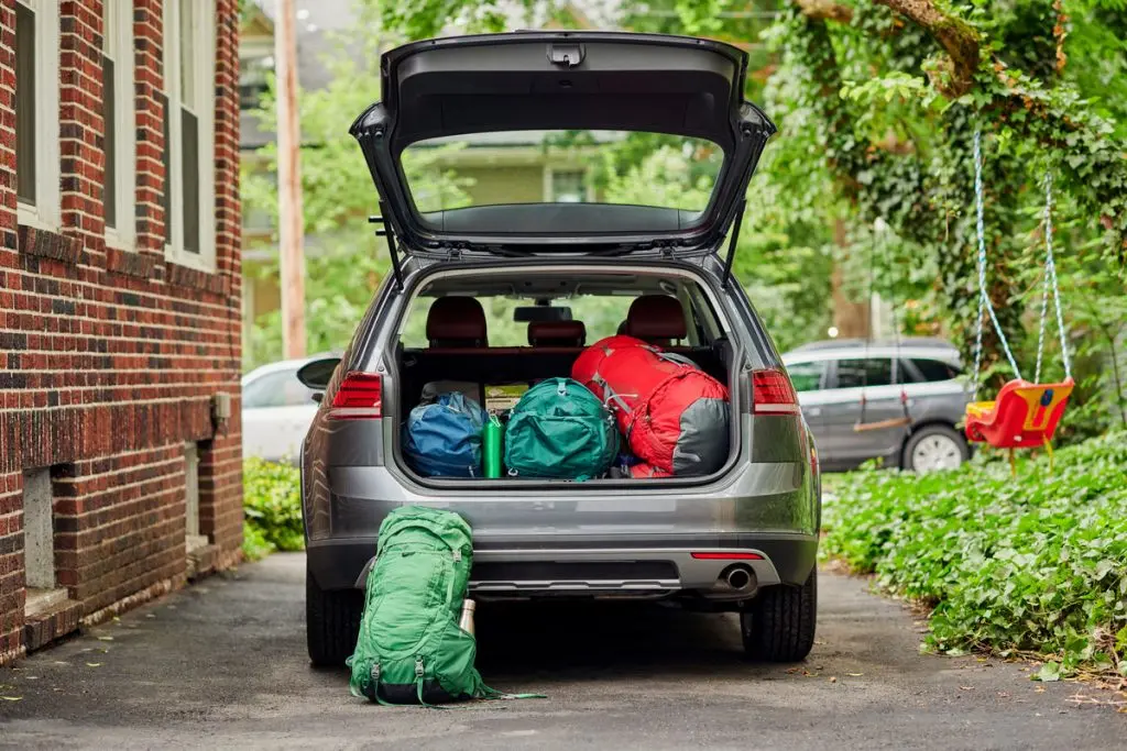 A family car getting packed up for a camping roadtrip in New England