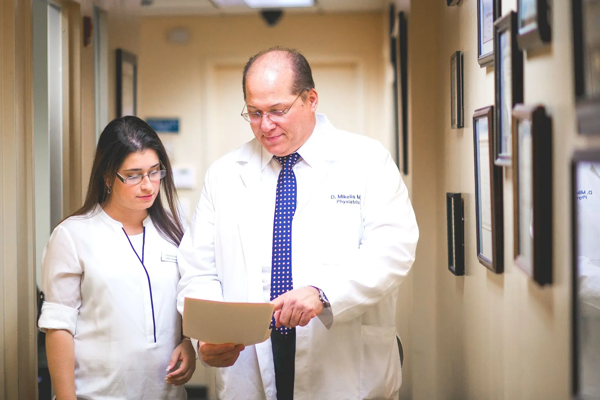 Spine specialist in New York reviewing treatment notes with a patient during consultation.