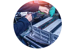 hands working on a car battery