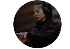 Woman wiht headphones on checking her smart wach