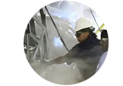 Two workers performing vacuum impregnation on a vehicle