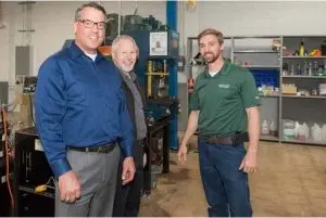 Three men in the Greenville repair center grand opening