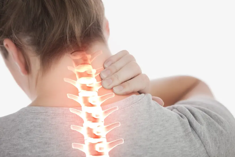 Woman holding neck and upper back in pain with red highlighted spine overlay - cervical strain or repetitive motion injury symptom.