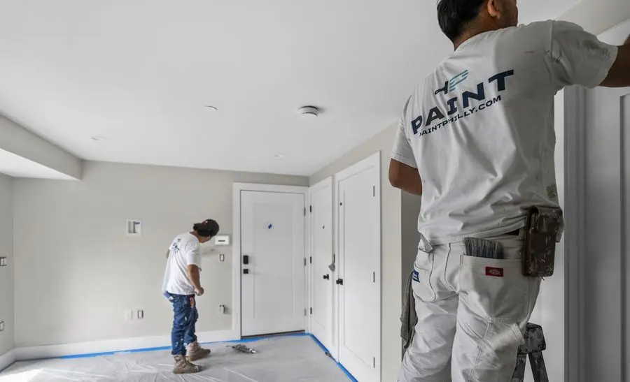 PAINT crew painting an interior hallway