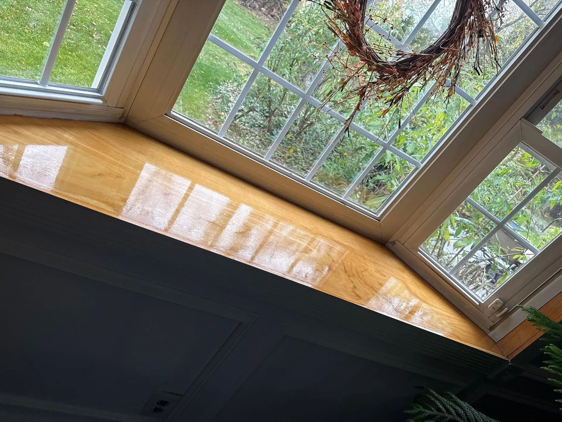 Custom carpentry and trim repair on a bay window in a Blue Bell, PA home by PAINT Philadelphia