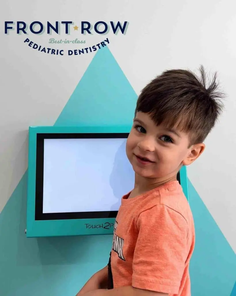 boy next to check in station at Front Row Pediatric Dentistry in Howard County Maryland