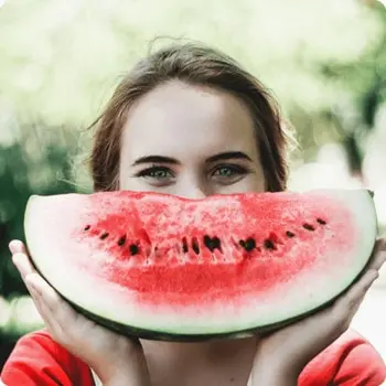 girl holding up watermelon